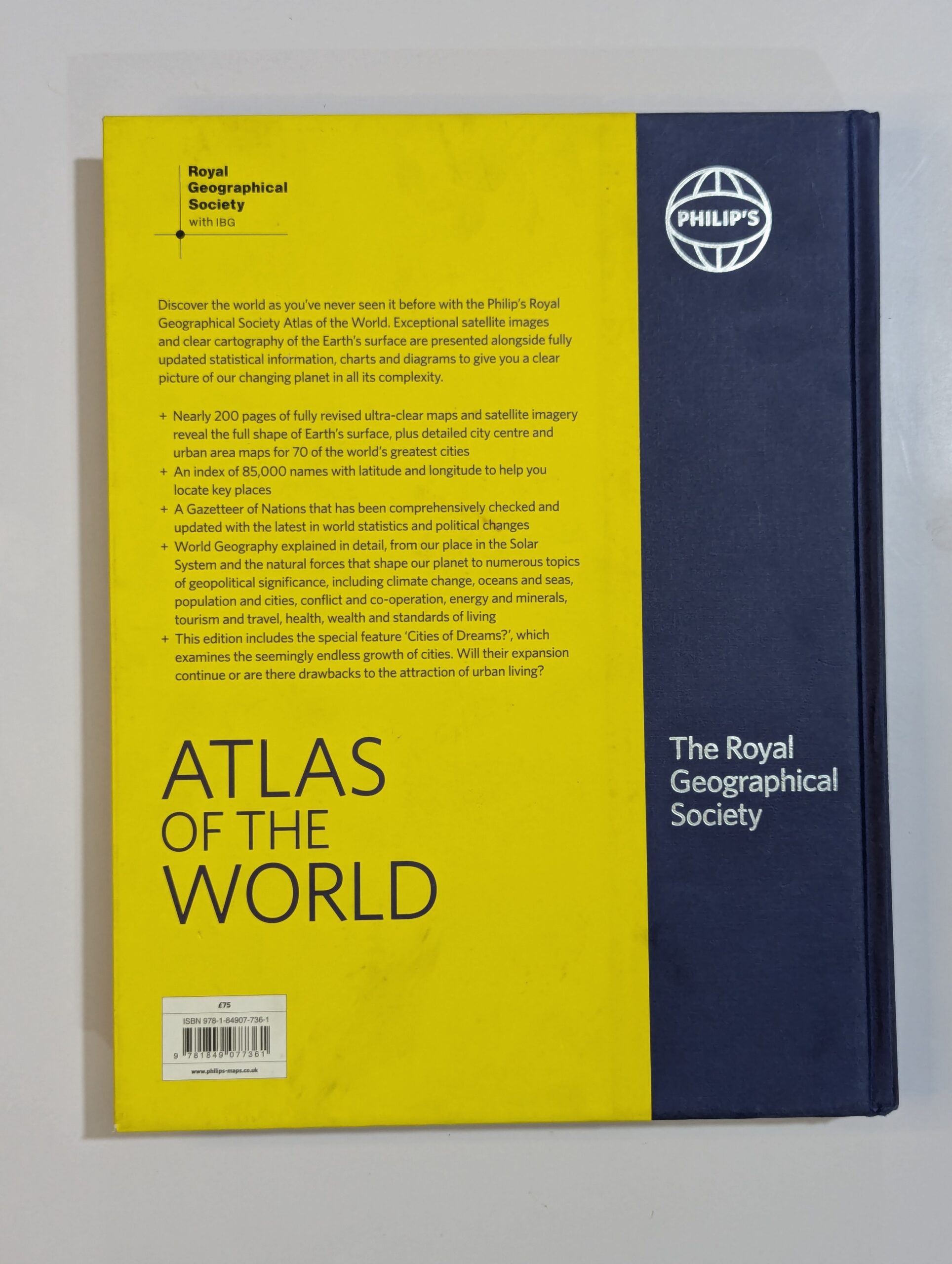 Inside spread from Atlas of the World showing detailed world maps, satellite imagery, and geographical data