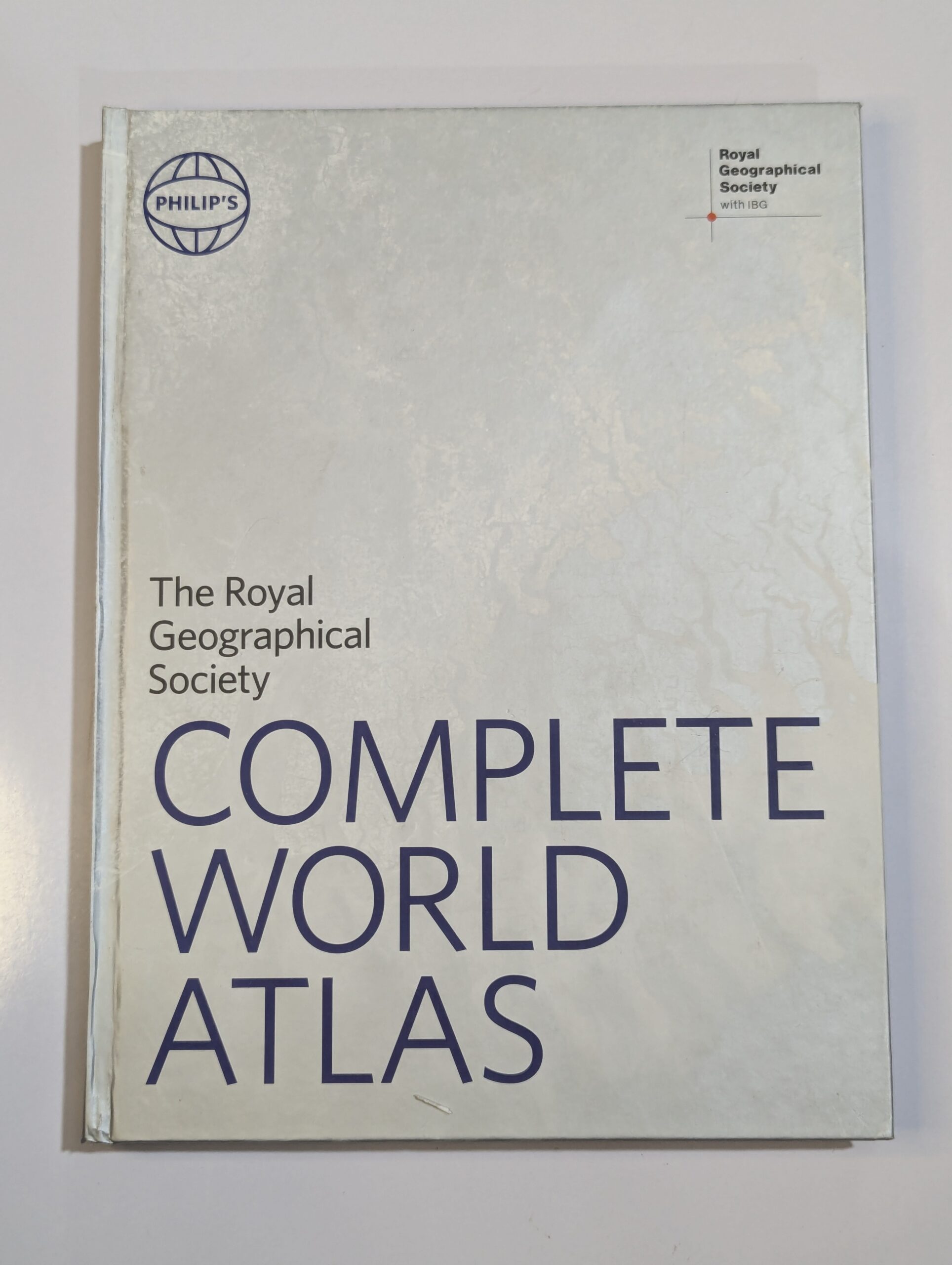 World atlas book cover — The Royal Geographical Society Complete World Atlas by Philip's — comprehensive geographical reference with physical and political maps