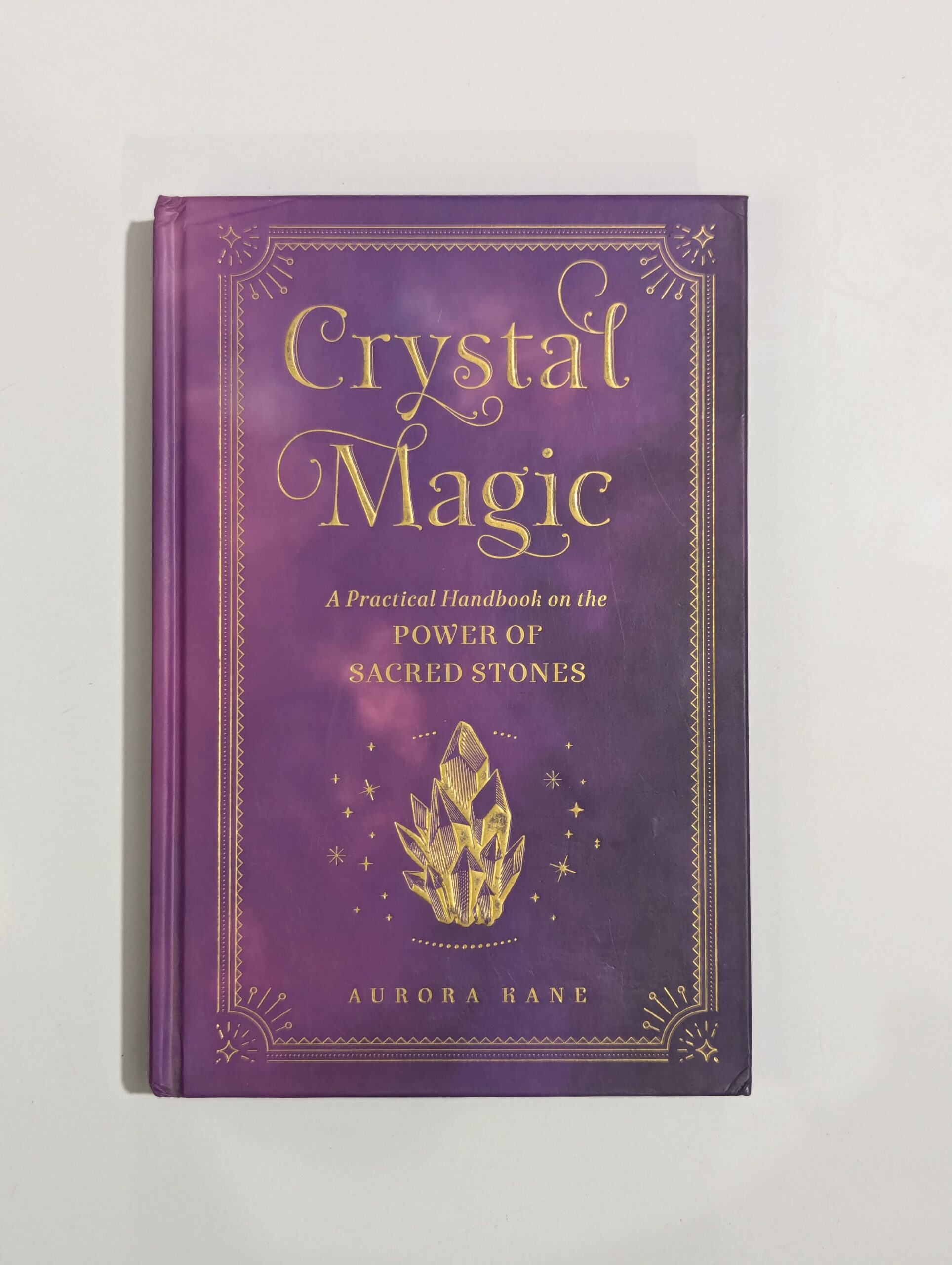 Crystal Magic book cover by Aurora Kane — practical handbook on the power of sacred stones — crystal healing and energy guide